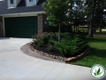 landscaped driveway  through mulch, plants and grasses