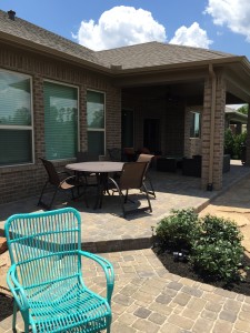 Brick paver patio and bushes in Katy, TX