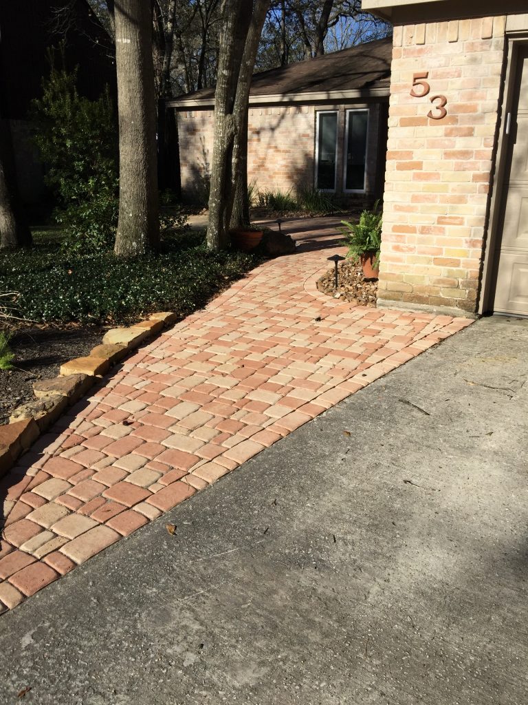 Brick patio and concrete pathway in Cloverleaf